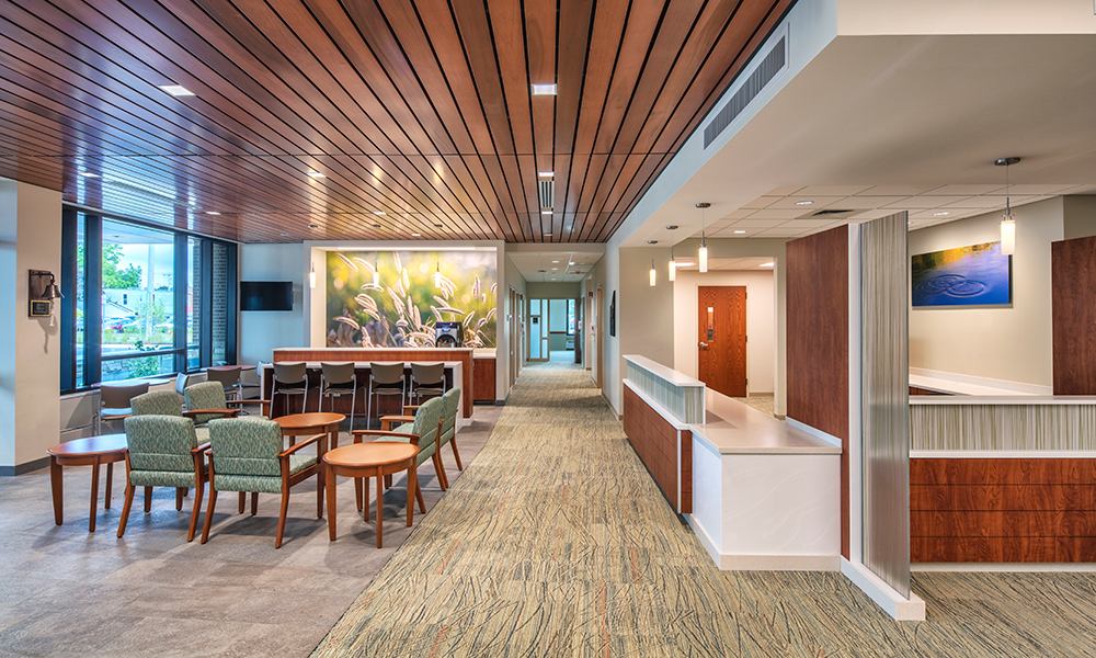 <p>The lobby’s wood finishes and uplifting graphics create comfort for new and returning patients.</p>

