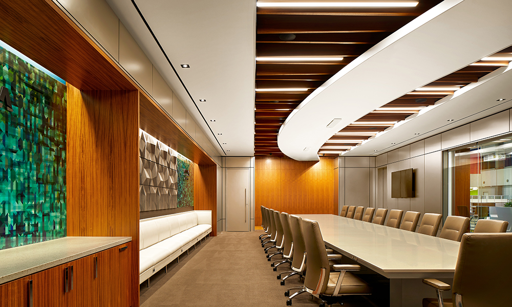 <p>A new executive boardroom provides a custom designed table with seating for 25, and an additional perimeter bench for 10.  Top tiered technology enables seamless and intuitive A/V display and wireless communications tools accessible by touchscreen. The room design highlights the Vistra brand with a horizon shaped ceiling element, brand palette inspired glass walls and logo, packaged in a sophisticated and elegant custom mill work teak wood wall paneling, prefabricated metal panels, and acoustical wall treatment elements.</p>
