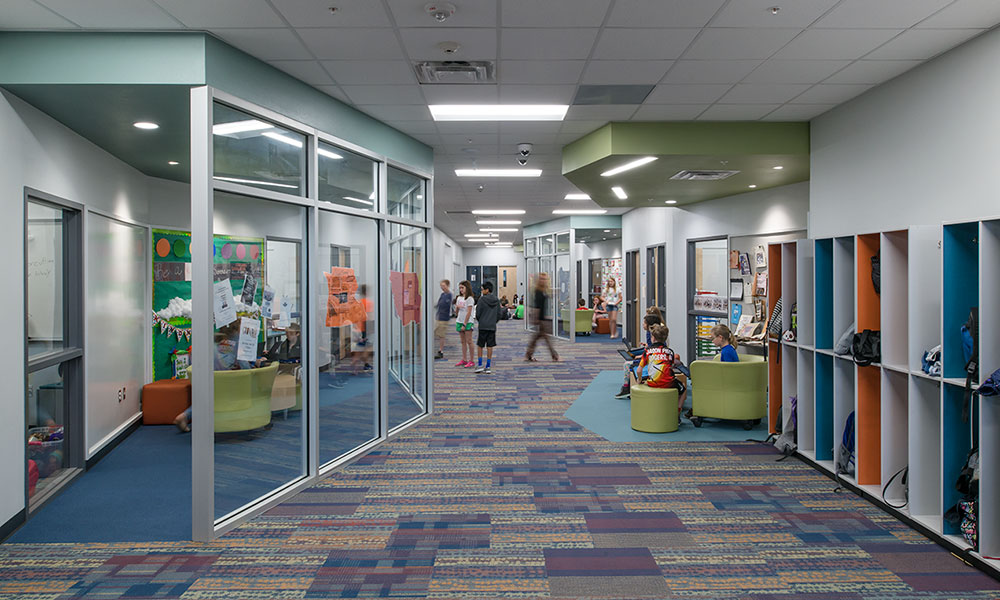 <p>The center corridor has been widened in a way that defines a variety of small enclosed group rooms and open group clusters, all of which can be easily supervised from the adjacent science labs and classrooms.</p>
