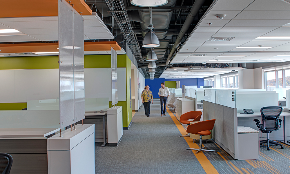 <p>The finishes within the building all focus on Sanofi’s brand and image with boldly colored accent walls and ceilings. Flooring patterns with accent bands also activate the spaces. More efficient desk layouts allow for more collaborative space with every station adjustable, accommodating ergonomic preferences and promoting the health and well-being of each worker. </p>
