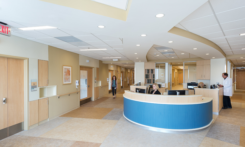 <p>The patient rooms are organized around a uniquely shaped support core that combines central and decentralized caregiver elements and allows for superior sightlines to aid in patient visualization and staff communication.</p>
