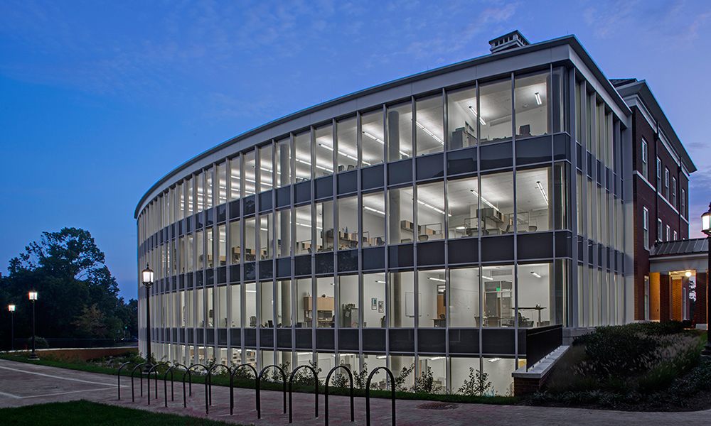 <p>The building’s opposite exterior has a decidedly more modern look, with a convex glass facade that offers views of the woods behind the Baltimore Museum of Art.</p>
