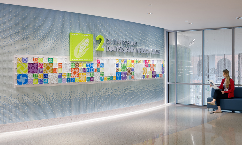<p>Visitors are greeted by wayfinding that uses unique colors for each floor and graphic icons linked to the patchwork quilt concept, depicting Iowa’s vibrant farmlands, woodlands, prairies, rivers, and skies.</p>
