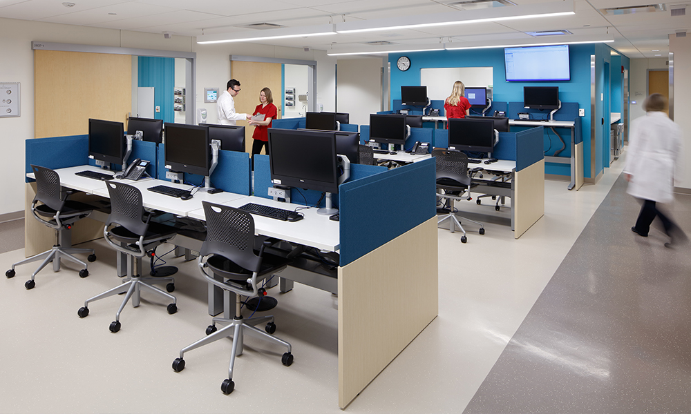 <p>Centralization of care team work areas are strategically located between two rows of exam rooms to improve staff efficiencies and provide easy access to their computer work stations and team huddle rooms, in between patient visits.</p>

