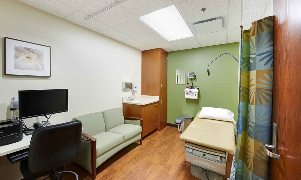 <p>Spacious exam rooms provide a homelike sensibility with the use of natural woods and “nature” themed fabrics and finishes.</p>
