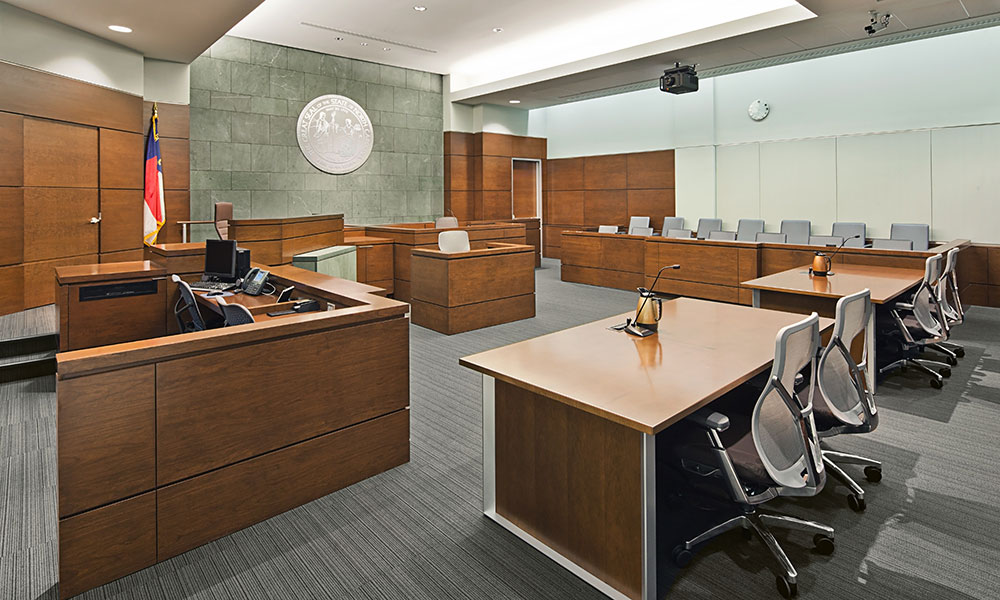 <p>Balanced by perforated acoustical wall panels, rich FSC-certified wood veneer panels bring warmth and civility to the courtrooms. </p>
