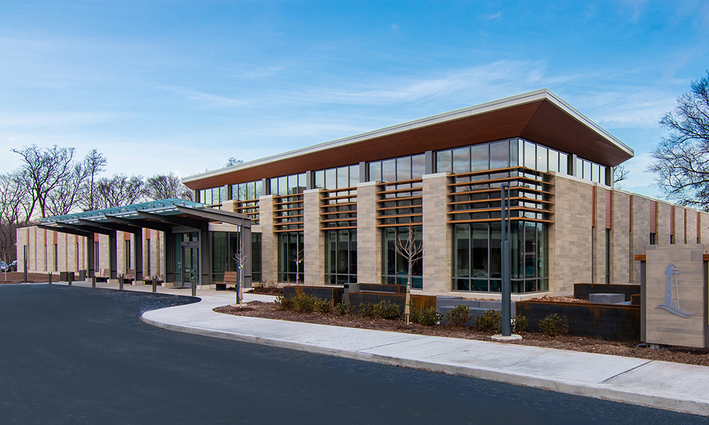 <p>The exterior building materials were designed to uniquely mirror the existing hospital campus’ typology. The Center’s façade includes ashlar cast stone, aluminum framed glass walls, wood plank panels, horizontal sun shade louvers and an exposed steel and glass drop off canopy.</p>
