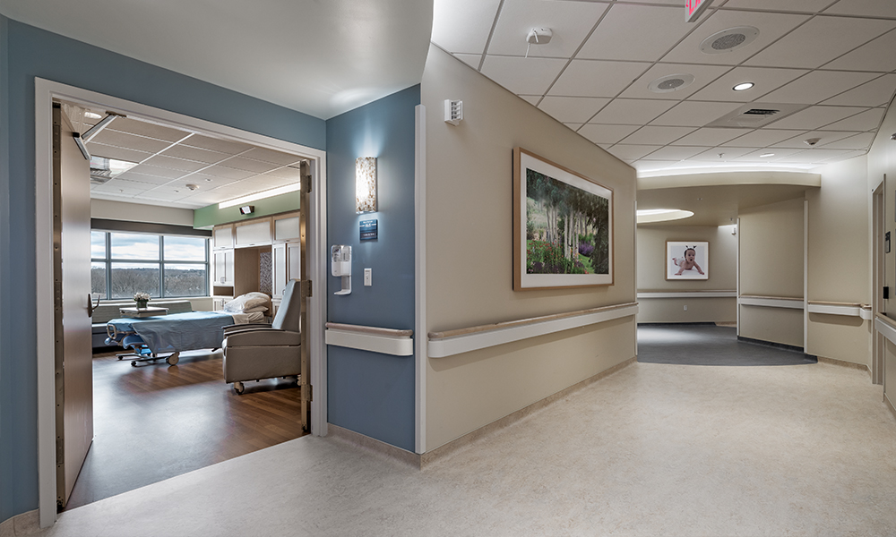<p>The Nurse Pods are connected to a public corridor that encircles the building core, preventing visitor and staff traffic from entering the area in front of patient rooms. This design allows better infection control separation and a quieter unit without the need of walls.</p>
