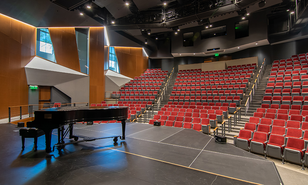 <p>A 415 seat, steep rake theater utilizes the hillside to reduce the scale of the building and nestle its large form into the historic context. Angled walls provide visual interest and improved acoustics.</p>
