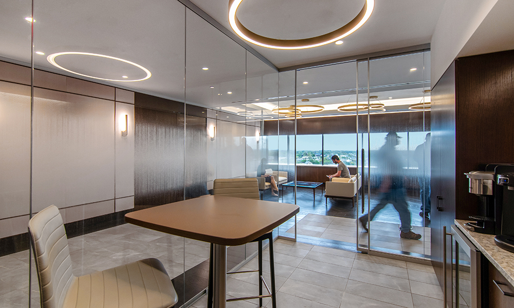 <p>The new workplace includes transparent design elements throughout, for visual access into offices, guest coffee bar, and meeting rooms.</p>
