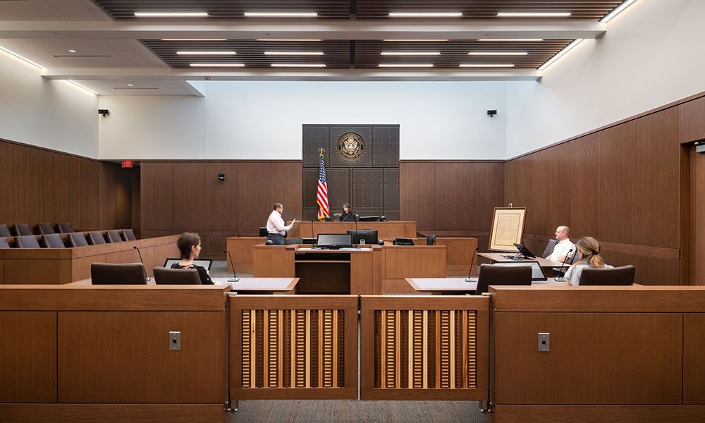 <p>The courtrooms are developed as simple formal spaces, with the bench, witness box and jury box placed much like furniture within the room. These strong ordered volumes promote the dignity of the judicial proceedings and provide a suitable theater for the adjudication of multiple proceedings. Each courtroom has a central bench which is reinforced in the planning and design of the room’s volume.</p>
