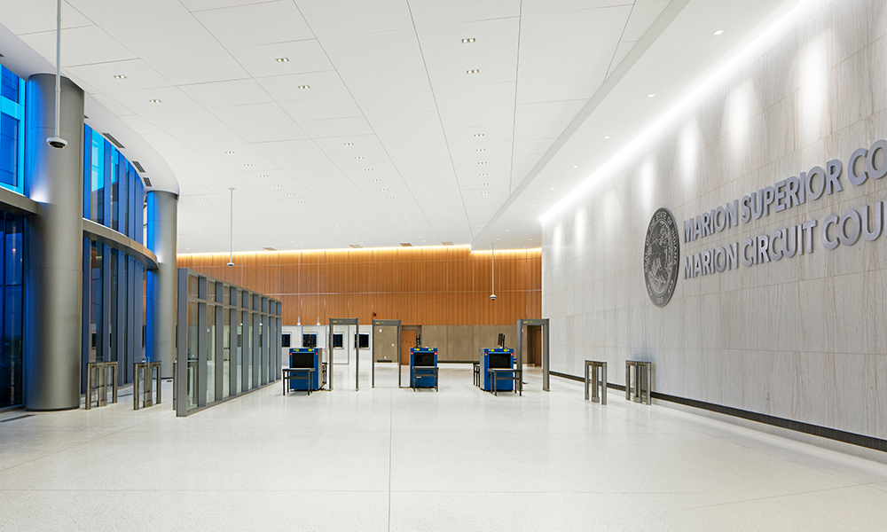 <p>The entry lobby serves as the central point for the public to access the courts or sheriff. Wood tones provide an inviting feel to the lobby while transparency allows daylights and views to the landscape and city beyond.</p>
