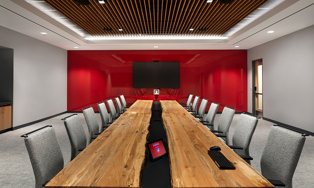 <p>A 23′ live-edge board room table, made with reclaimed wood from the site, was designed by SLAM.</p>
