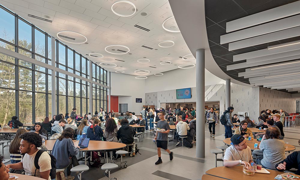 <p>A common servery supports unique dining spaces for the middle school and high school. Each has floor-to-ceiling glass and ample natural light.</p>
