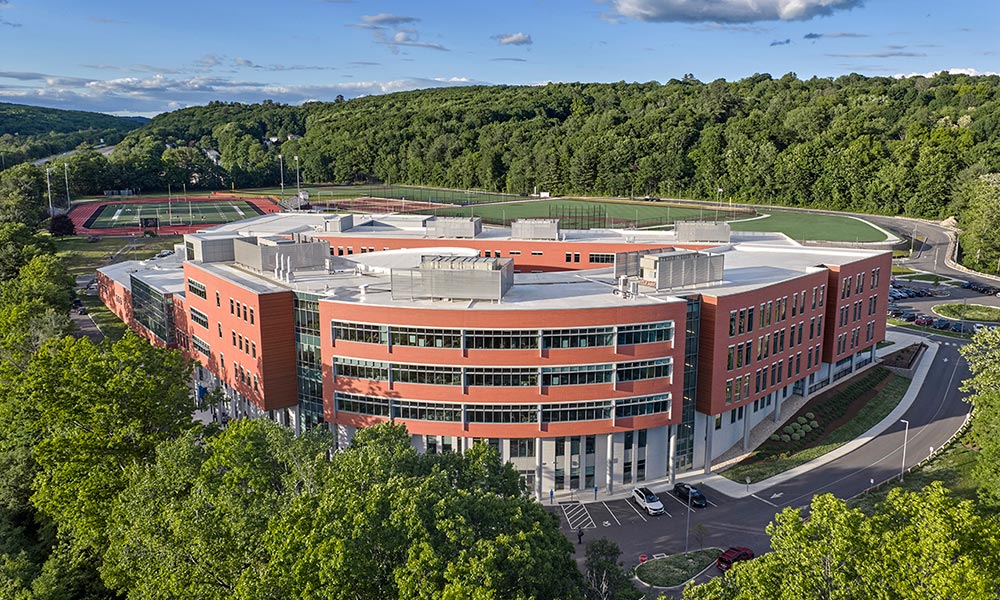 <p>Situated on the sloping southwest portion of the site, the new complex enabled SLAM landscape architects to maximize the northern and eastern quadrants for athletic fields, supporting both middle and high school sports. The entire building and site is ADA accessible. A new pre-school playground is located on the Besse Park side of the high school building, which is part of the on-site school readiness program that also supports an early education pathway at the high school.</p>

