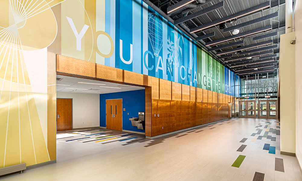 <p>As students traverse the concourse, they are surrounded by floor-to-ceiling graphics that inspire, embrace, and unify the culturally-diverse population, framing the view to the heart of the building: the student commons. </p>
