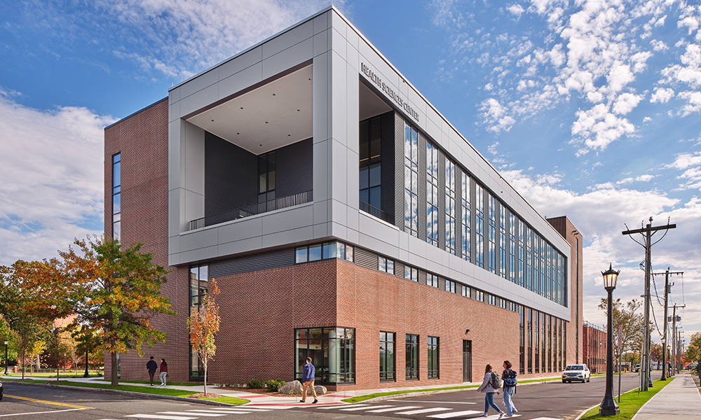 <p>The city side is defined by aluminum panels and a framed box that contains all the learning spaces. This gives the facility a contemporary expression as you approach from the city showcasing the new campus direction.</p>
