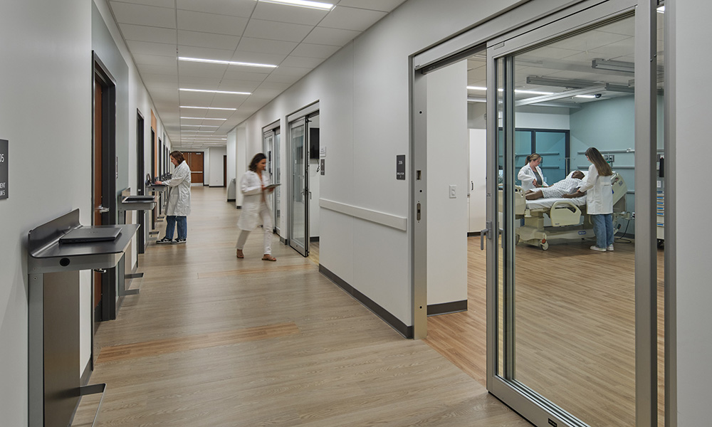 <p>The Simulation Center located at the second floor landing includes inpatient and outpatient settings with training space for “Standardized Patients” – community members who provide training to PA students by recounting medical histories and symptoms to prepare learners for clinical care.</p>
