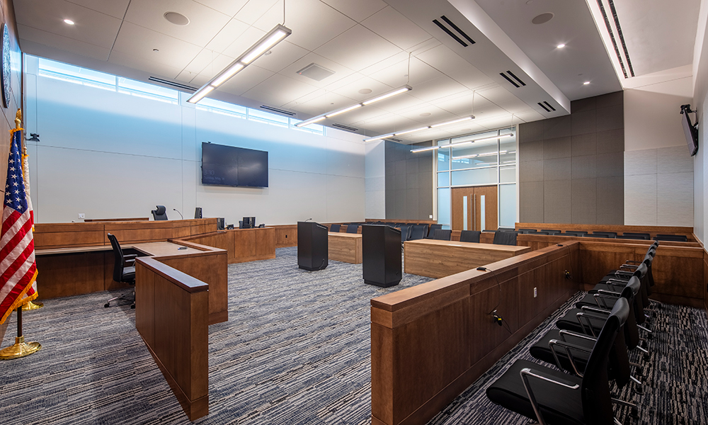 <p>The courtrooms feature a subdued, complementary material palette that contrasts with the vibrant, active public areas, creating a calm and focused environment that supports concentration and the formality of legal proceedings.</p>
